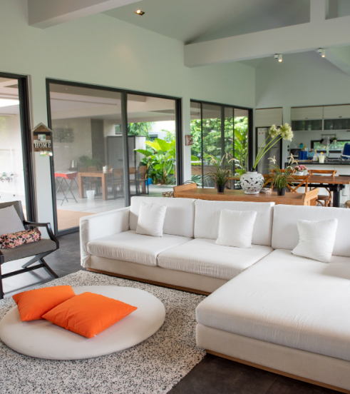 A stylish white sectional couch positioned in a contemporary living space, enhancing the room's aesthetic.